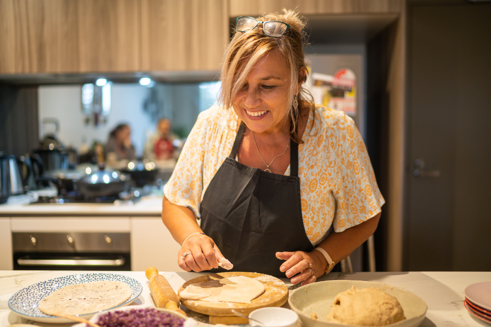 Woman smiling in an Indian vegan cooking class